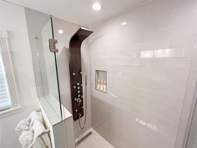 bathroom with a tile shower