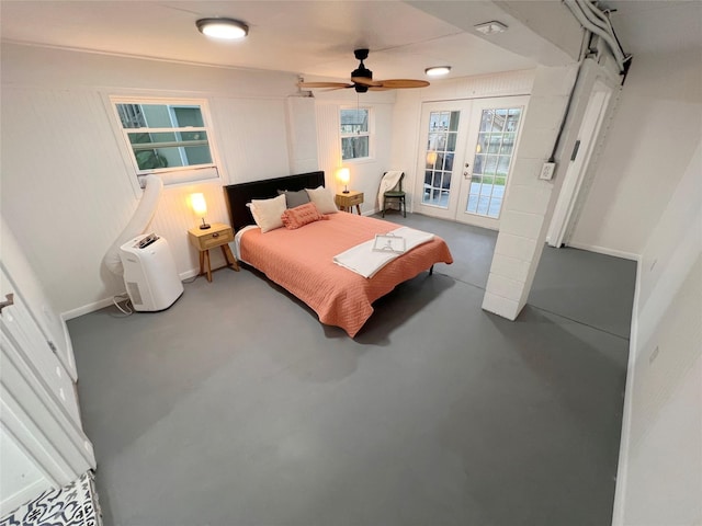 bedroom with ceiling fan, access to exterior, concrete flooring, and french doors