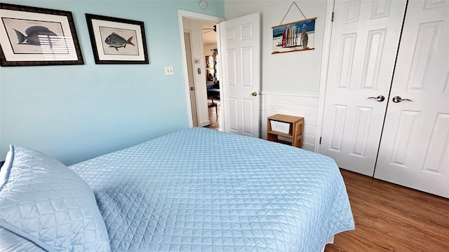 bedroom with wood-type flooring and a closet