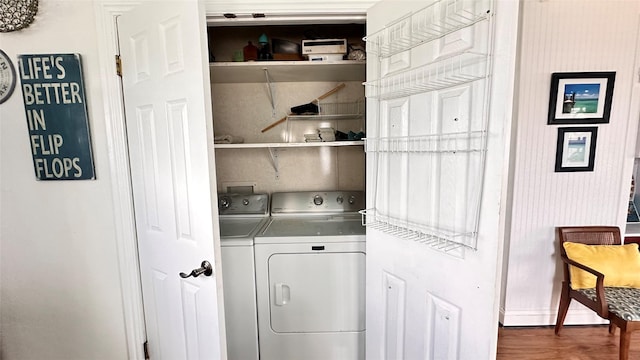 laundry area with washer and dryer and dark hardwood / wood-style floors