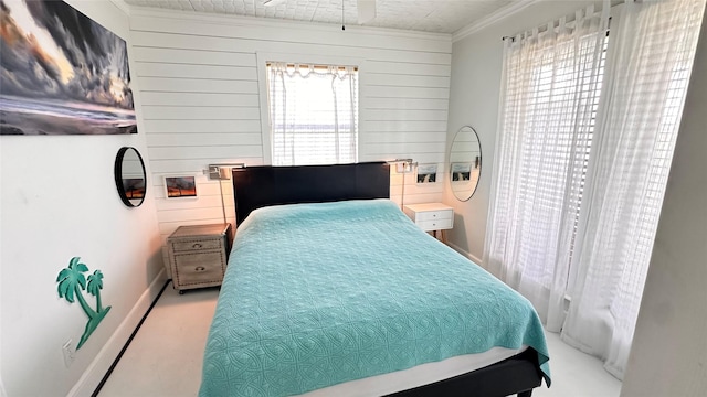 bedroom with light colored carpet, ornamental molding, and wooden walls