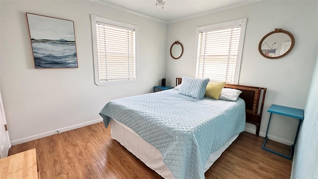 bedroom featuring hardwood / wood-style flooring and crown molding