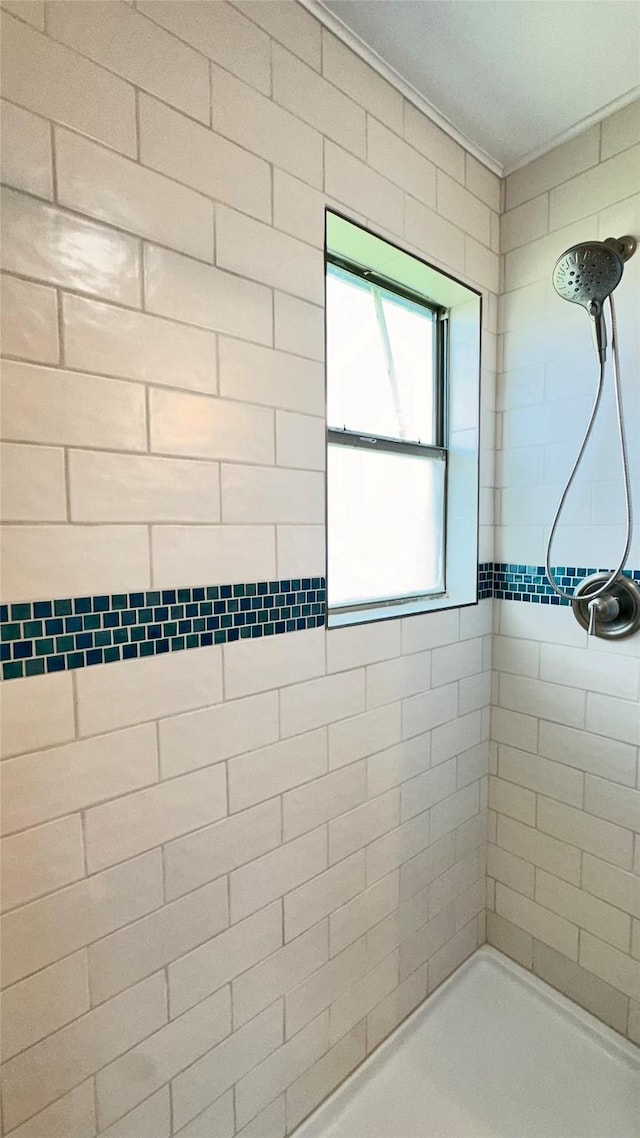 bathroom with a tile shower