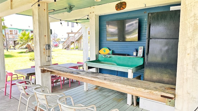 wooden terrace with an outdoor bar