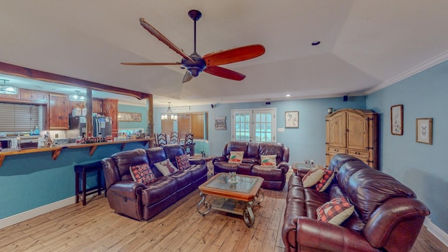 living room featuring crown molding, light hardwood / wood-style floors, and ceiling fan with notable chandelier