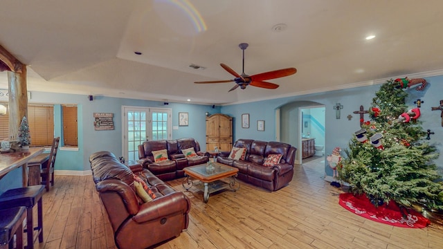 living room featuring french doors, light hardwood / wood-style flooring, ceiling fan, and ornamental molding