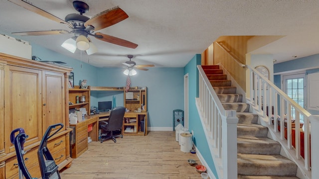 office featuring a textured ceiling, light hardwood / wood-style flooring, and ceiling fan