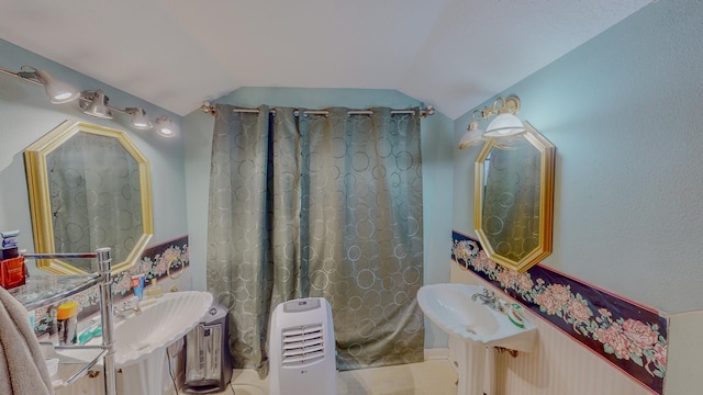 bathroom featuring lofted ceiling