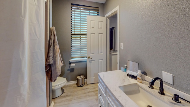 bathroom featuring hardwood / wood-style floors, vanity, and toilet