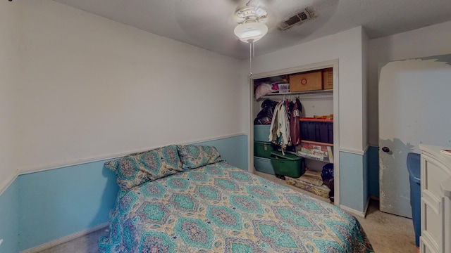 carpeted bedroom featuring ceiling fan and a closet