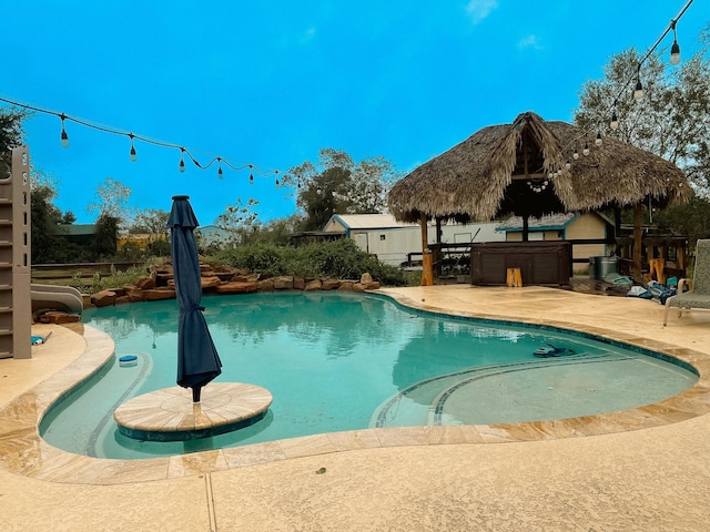 view of swimming pool with a gazebo, a jacuzzi, and a patio