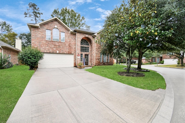 view of front facade with a garage and a front lawn