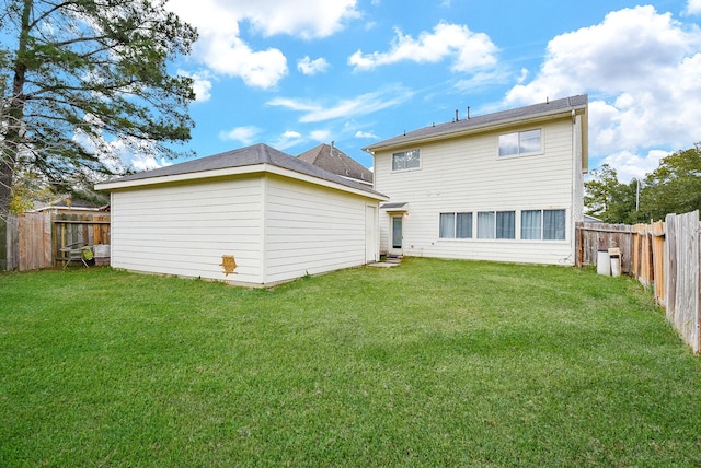 rear view of property with a lawn