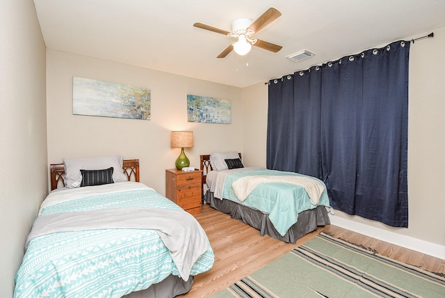 bedroom with ceiling fan and hardwood / wood-style floors