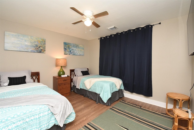 bedroom with ceiling fan and hardwood / wood-style flooring