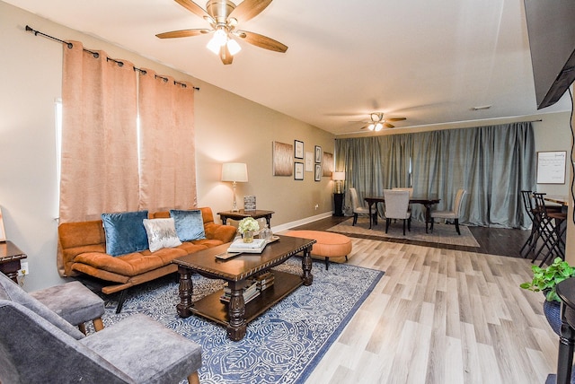 living room featuring ceiling fan and wood-type flooring