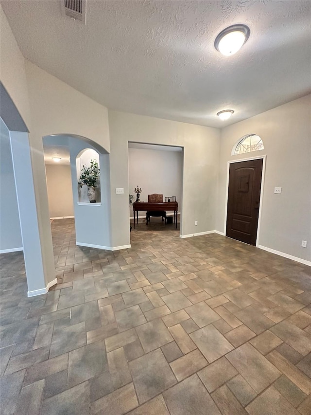 entryway featuring a textured ceiling