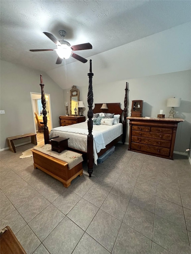 bedroom with tile patterned floors, ceiling fan, lofted ceiling, and a textured ceiling