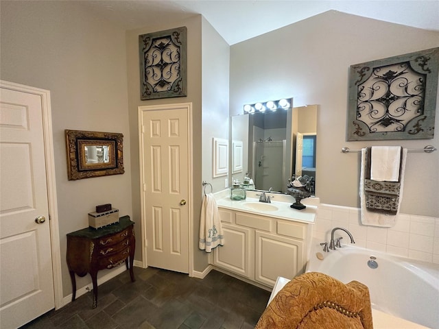 bathroom with shower with separate bathtub, vanity, and lofted ceiling