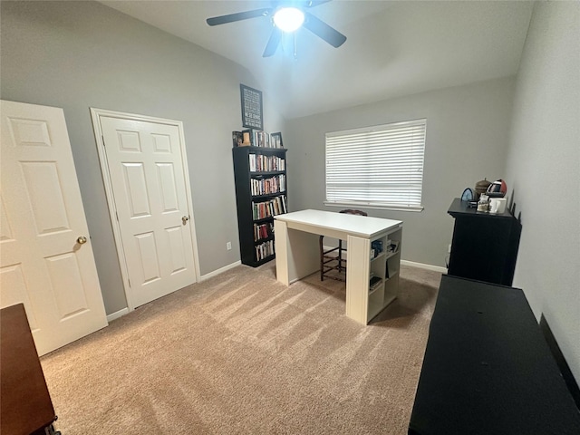 carpeted office with ceiling fan and vaulted ceiling