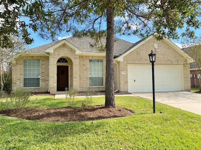 ranch-style house featuring a front yard and a garage