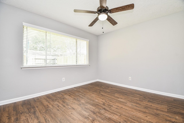 spare room featuring a textured ceiling, ceiling fan, and dark hardwood / wood-style floors