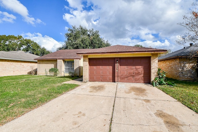 ranch-style home with a garage and a front lawn