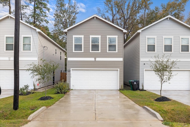 view of front facade featuring a garage and a front lawn