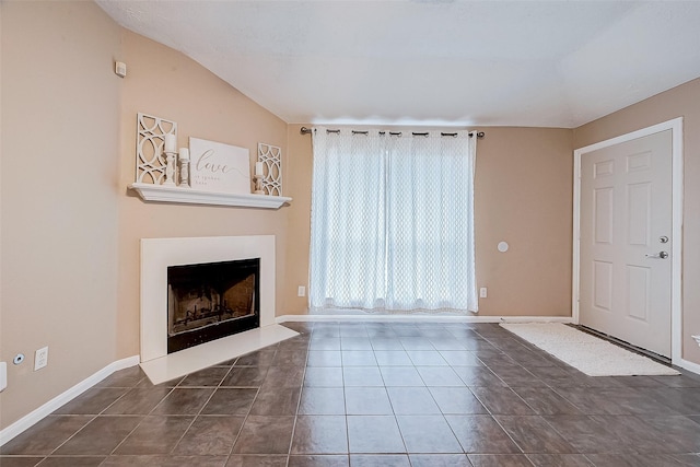 unfurnished living room featuring dark tile patterned flooring