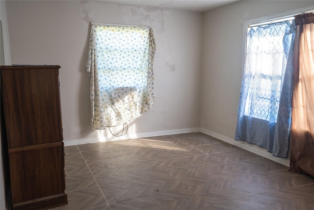 unfurnished room with dark parquet floors