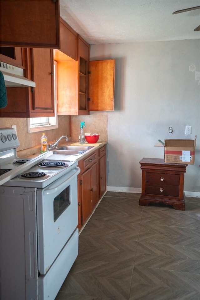 kitchen with dark parquet flooring, white range with electric cooktop, ceiling fan, and sink