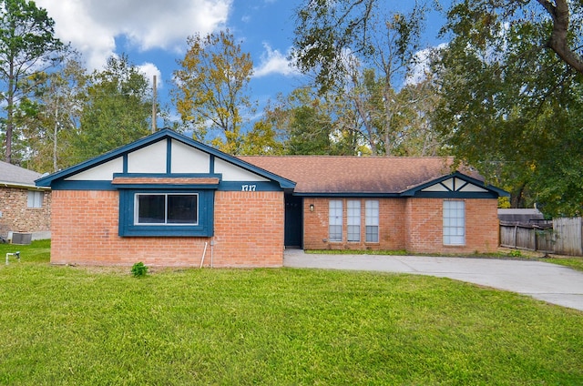 ranch-style house with central AC unit and a front lawn