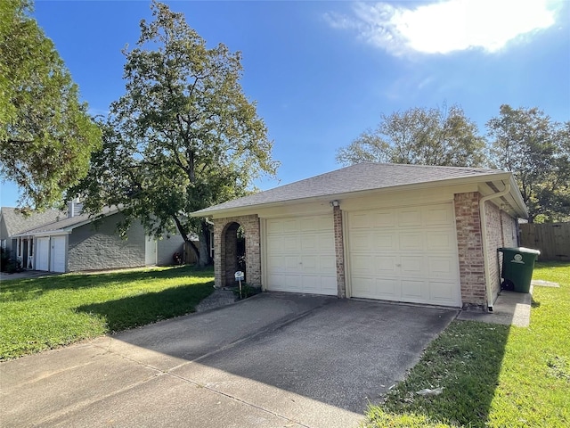 view of front facade with a garage, an outdoor structure, and a front yard