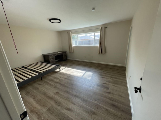 unfurnished bedroom with dark hardwood / wood-style floors