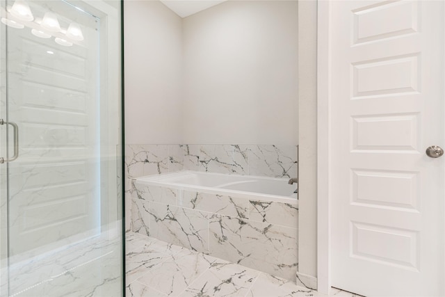 bathroom featuring separate shower and tub