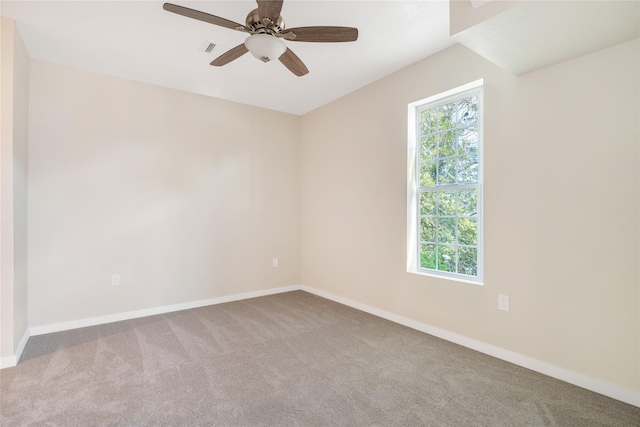 carpeted spare room featuring ceiling fan