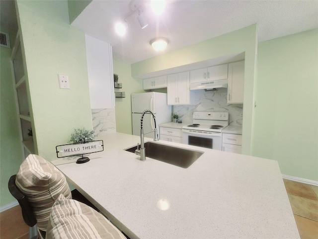 kitchen featuring backsplash, kitchen peninsula, sink, white appliances, and white cabinets