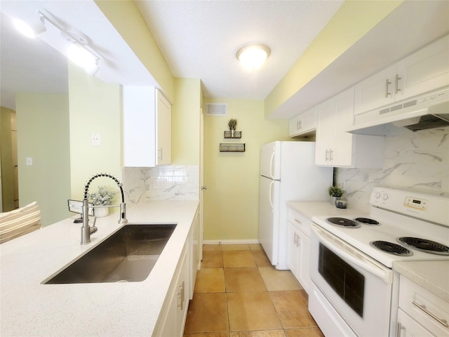 kitchen with white cabinetry, sink, tasteful backsplash, and white appliances