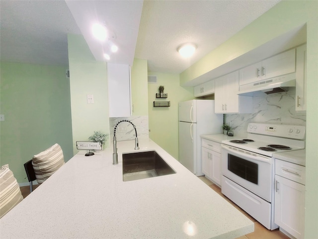 kitchen with white cabinetry, kitchen peninsula, tasteful backsplash, white appliances, and sink