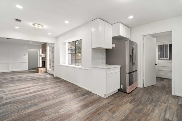 kitchen with white cabinets, stainless steel fridge with ice dispenser, and dark wood-type flooring