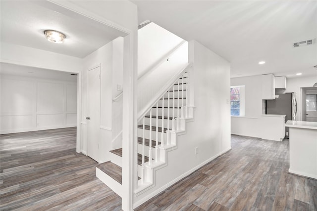 stairway featuring hardwood / wood-style floors