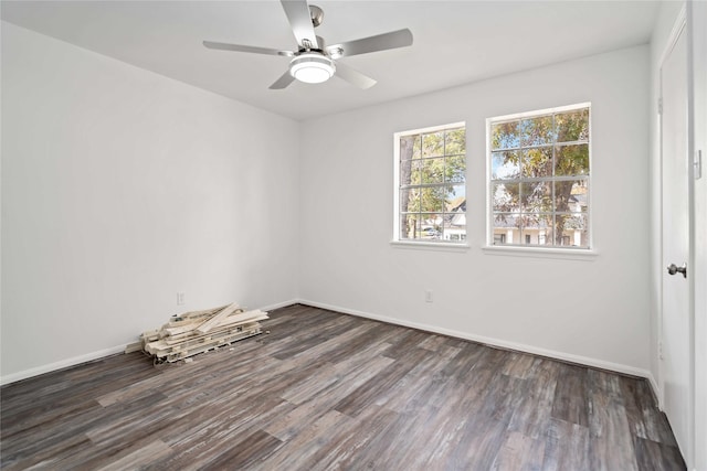 spare room featuring ceiling fan and dark wood-type flooring