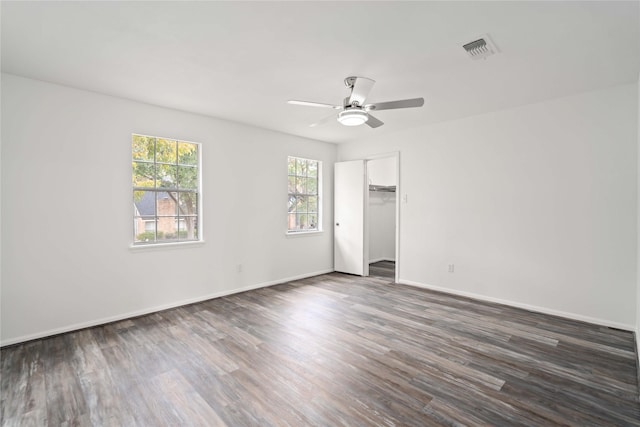 spare room with ceiling fan and dark hardwood / wood-style flooring