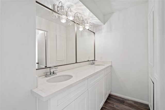 bathroom with vanity, a notable chandelier, and hardwood / wood-style flooring