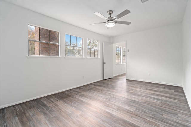 unfurnished room with ceiling fan and dark wood-type flooring