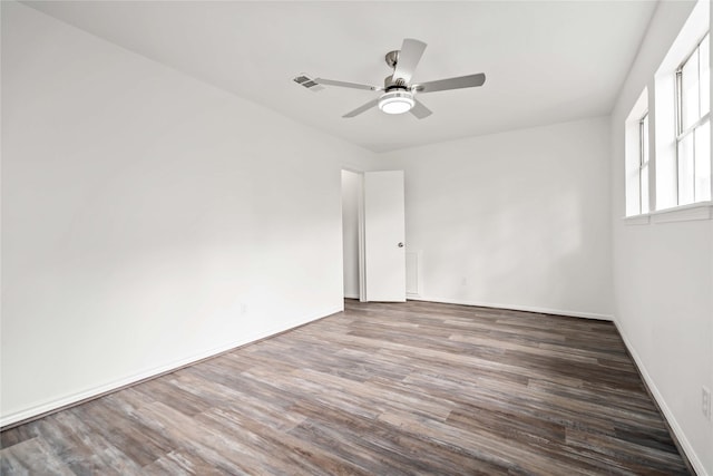 unfurnished room with dark hardwood / wood-style flooring and ceiling fan