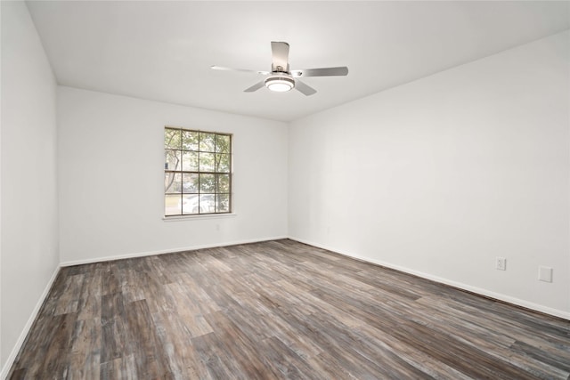 spare room with ceiling fan and dark wood-type flooring