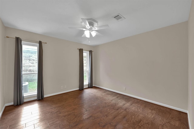 empty room with dark hardwood / wood-style floors and ceiling fan