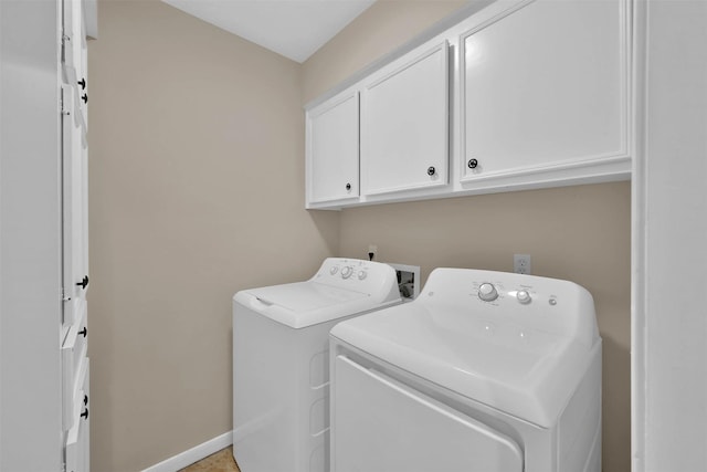 washroom with cabinets and washing machine and dryer