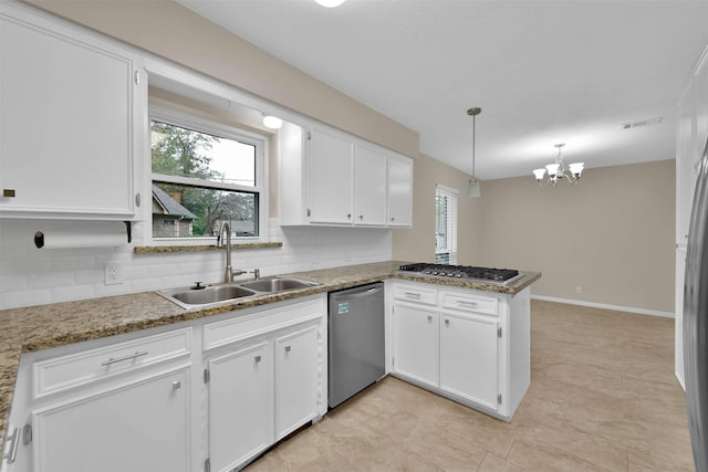 kitchen featuring pendant lighting, white cabinets, sink, appliances with stainless steel finishes, and kitchen peninsula